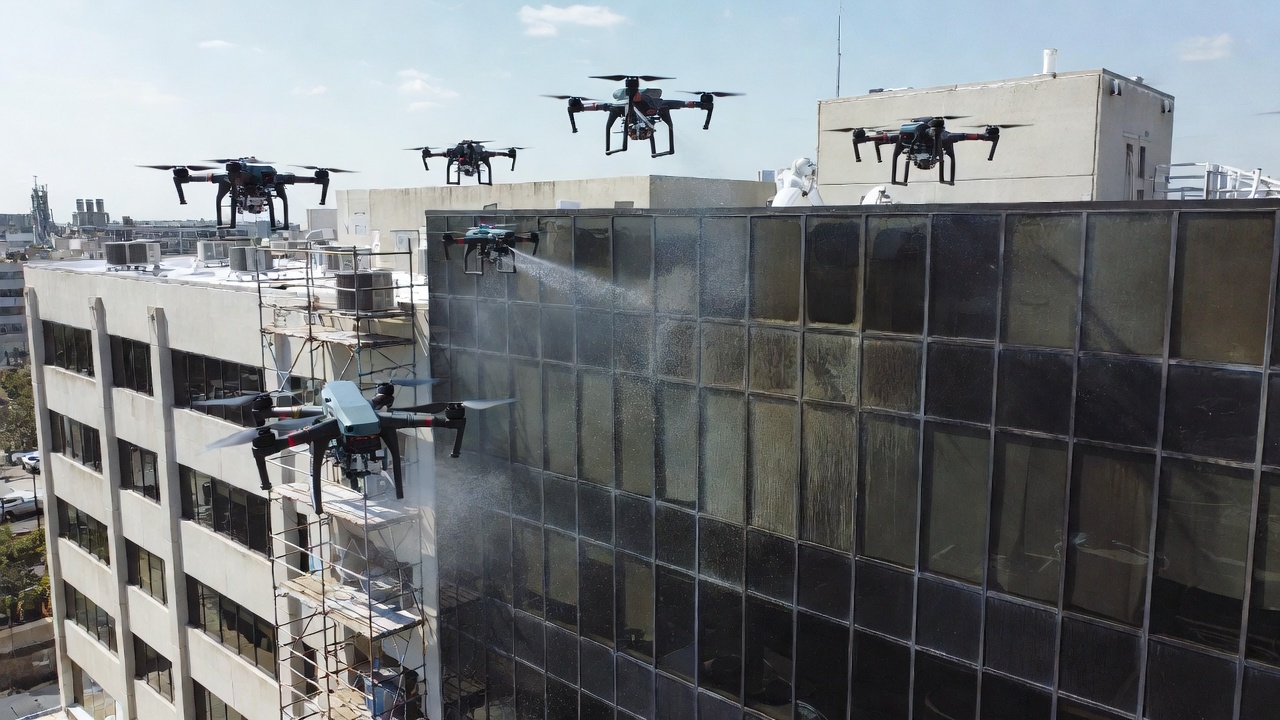 Commercial drone pressure washing exterior brick building